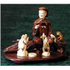 Image 1 : A Japanese carved ivory and hardwood figure group depicting a man seated on a...