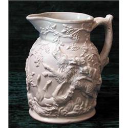 A 19th century Parian type stoneware jug relief decorated with hunting scenes...