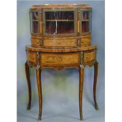 A French 19th Century demi-lune cabinet, the interior fitted a shelf enclosed by glazed panelled...