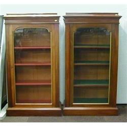 A pair of Victorian mahogany bookcases the interiors fitted adjustable shelves enclosed by arched...