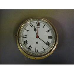 A Ward Room clock, the 7" enamelled dial with Roman numerals contained in a gilt metal case    £5...
