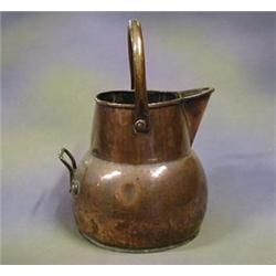 A 19th Century copper jug 9" £25-35...