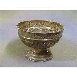 A circular embossed silver bowl raised on a socle base Birmingham 1914 9"  £100-150...