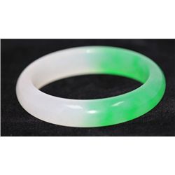 CHINESE GREEN AND WHITE JADE BANGLE; DIAMETER 2.5 IN