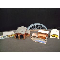 Box of building pieces and parts from HO scale train sets.