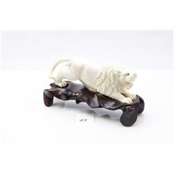 Genuine ivory carved lion figurine on wooden stand