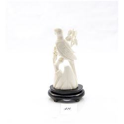 Genuine ivory carved bird figurine on wooden stand