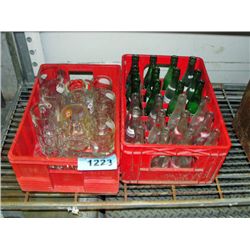 2 red plastic pop crates with vintage pop bottles