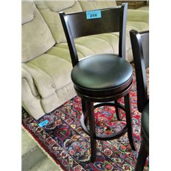 Swivel bar stool with black leather padded seat