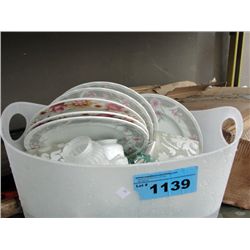 White tub of dishes and lamp shades