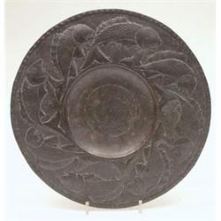 A Newlyn copper wall plate, broad rimmed and continuously embossed with fishes, unmarked, 12ins....