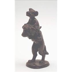 A comical cast bronze group, two dogs, one seated upon the other, 5.5ins. £50-70...