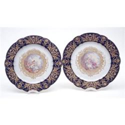 A pair of late 19th century Sevres porcelain plates painted with romancers in Watteau manner, one...