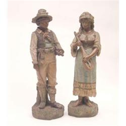 A pair of late 19th century Austrian earthenware statuettes, peasant musicians in traditional cos...