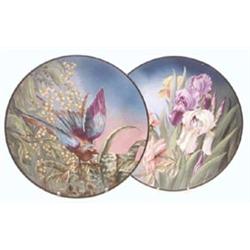 A pair of Longchamps earthenware wall plates brightly painted, one with a bird, the other with fl...