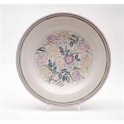 A Poole pottery wall plate brightly painted with foliage amidst concentric borders, 15.5ins £100-...