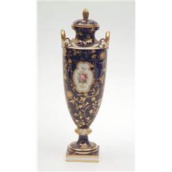 A Mintons bone china vase and cover, urn-shaped with gilded handles, painted with a bouquet of fl...