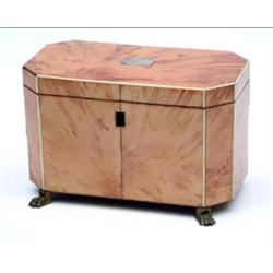 A Regency blond tortoiseshell rectangular 2-division tea caddy with canted corners on brass claw...