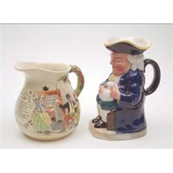 A Crown Devon musical jug moulded and painted with 'Auld Lang Syne', 7ins together with a Staffor...