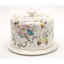 A late Victorian earthenware cheese dish and domed cover painted with a butterfly and flowers, 10...