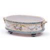 Image 1 : A 19th century French faience oval dish painted with a dove, cornucopia and foliage in polychrome...