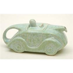 A Sadler earthenware novelty teapot in the form of an early coupe motor car with goggled driver f...