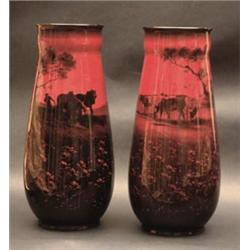 A pair of Royal Doulton flambe vases of tapering rounded form with ogee rim decorated with cattle...