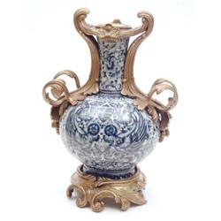 An ormolu-mounted blue and white porcelain vase of globe and shaft form, mounts in rococo style,...