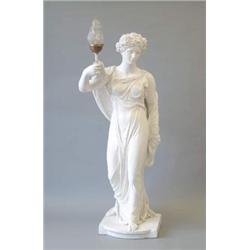 A late Victorian white painted earthenware figure of a muse with vineous hairpiece, holding a lan...