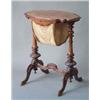 Image 1 : A Victorian walnut work box with shaped top over sliding silks box, on carved baluster columns an...