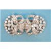 Image 1 : A platinum diamond set double dress clip/brooch of stylised scrolled ribbon design set brilliant...