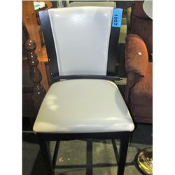 Counter height white leather padded chair