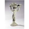 Image 1 : A lead bird bath, in the form of a shell and bird, supported by a putto with arms aloft, on a nat...