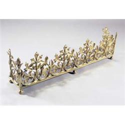 A gilt metal fender with foliate scrolls and fruit on bun feet, 113cm wide £800-1,200...