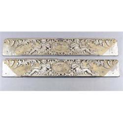 A pair of 19th century painted pine and parcel gilt rectangular panels, each carved with scrollin...