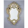 Image 1 : An early 19th century Italian giltwood wall mirror of cartouche shape carved with scrolls and fol...