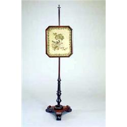 A George IV mahogany pole screen, with a turned finial, the woolwork canted rectangular rosewood...