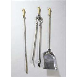 A set of three 20th century steel fireirons with gilt metal baluster handles £500-700...