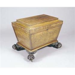 A William IV mahogany sarcophagus shaped cellaret, the hinged top with a concave edge, on taperin...