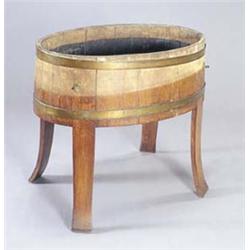 A walnut oval and brass bound wine cooler/jardiniere with a metal liner, and four outswept legs,...