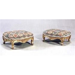 A pair of 19th century giltwood footstools, each of serpentine rectangular form, with a woolwork...