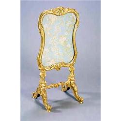 A mid 19th century giltwood firescreen, carved overall with flowers, scrolls and leaves, the cart...