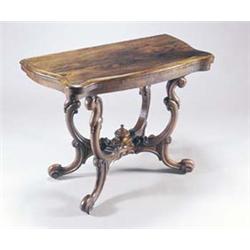 A Victorian rosewood card table, the folding swivel top of serpentine form with a moulded edge en...