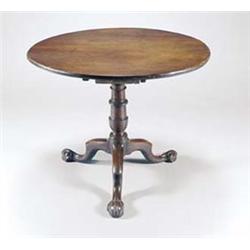 A mid 18th century walnut round tilt top table, on a birdcage and baluster turned column and thre...