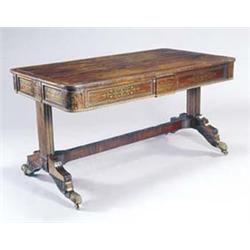 A George IV rosewood and brass strung and inlaid library table, the rectangular top crossbanded i...