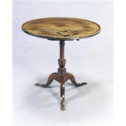 A mahogany tripod table, the round dished tilt top on a baluster turned column and turned cabriol...