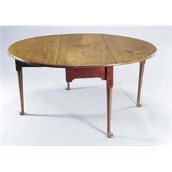 A mid 18th century mahogany oval drop leaf table, with a plain frieze to each end, on turned tape...