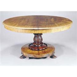 An early Victorian mahogany breakfast table, the round tilt top with a moulded edge on a lappet c...