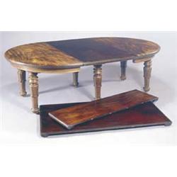 A William IV mahogany oval extending table with four loose leaves, the top with a rounded edge, a...
