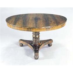 An early Victorian rosewood simulated and rosewood breakfast table, the round tilt top on a turne...